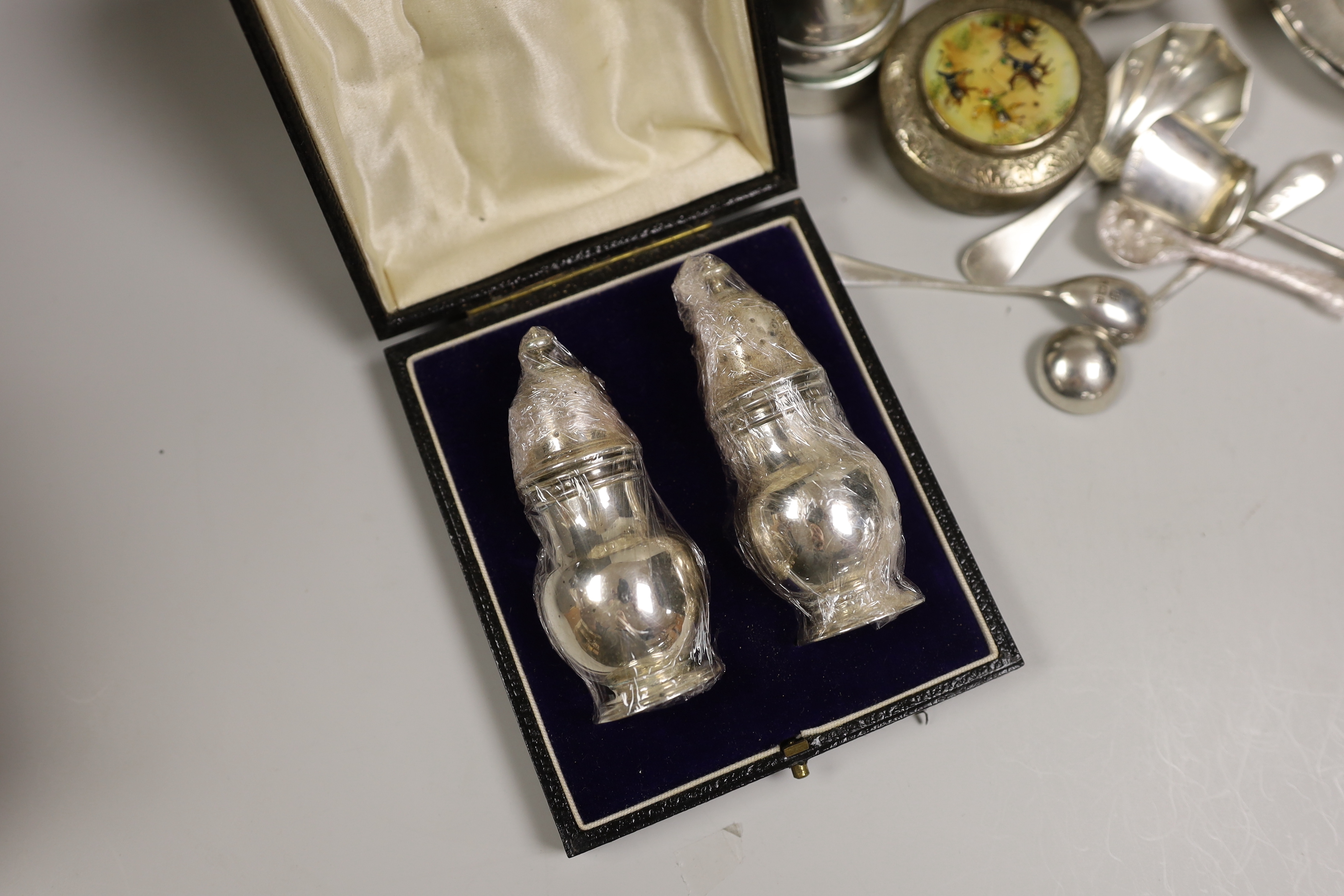 A mixed collection of small silver and plated items to include five various sauceboats, a cased pair of pepper pots, a chased Victorian sugar sifter, two caddy spoons, a silver mounted peppermill, two Chinese coin-set tr